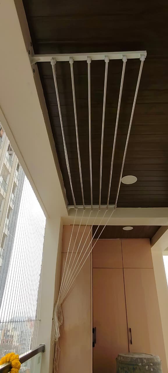 High-rise apartment balcony hanger above a wardrobe unit with a city view