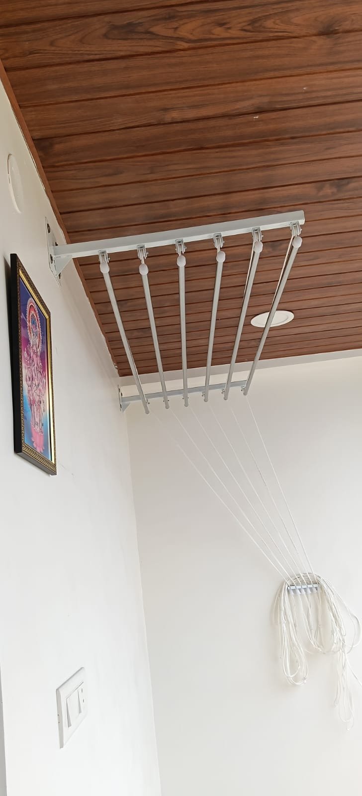 Ceiling cloth hanger on a wooden ceiling in a bright daylight balcony