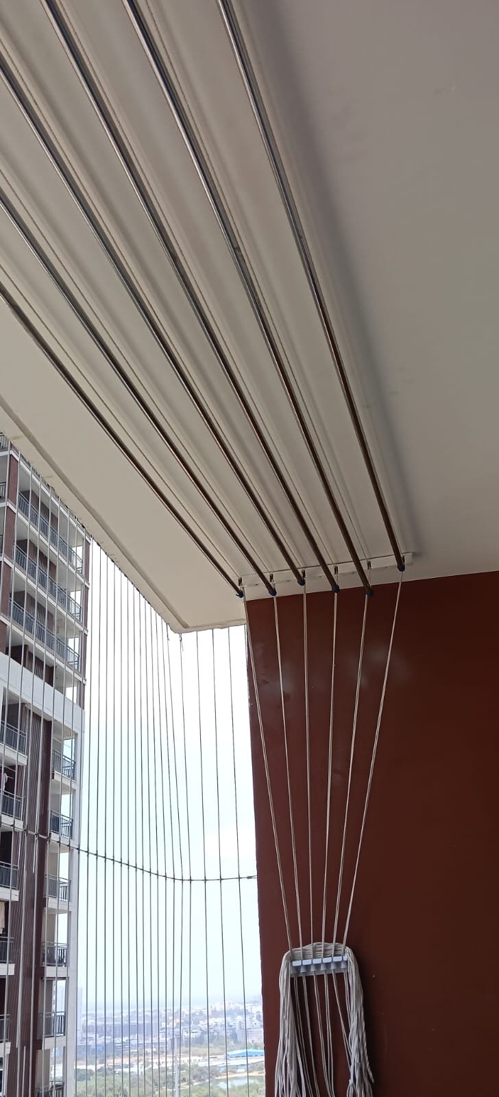 High-rise balcony ceiling hanger installation with wind-stable anchoring