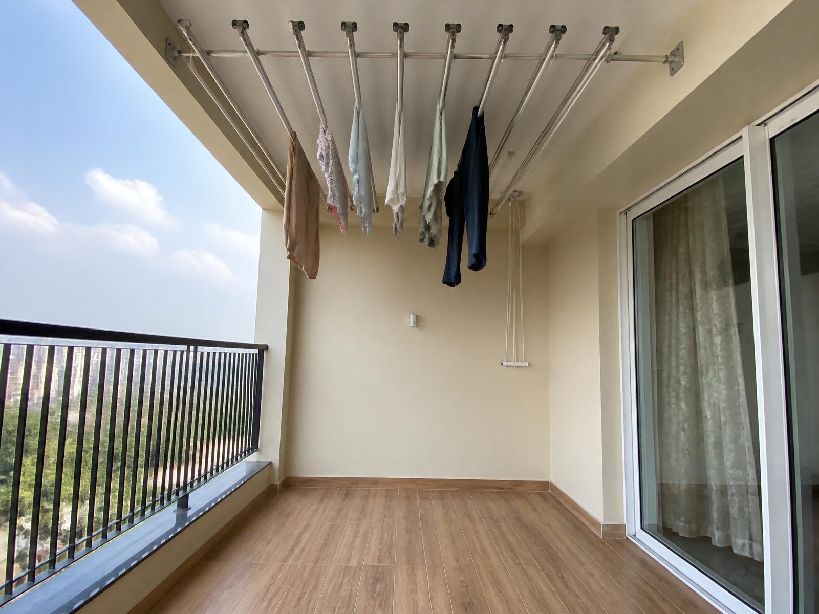 Apartment balcony with a stainless steel ceiling cloth hanger installed on the ceiling