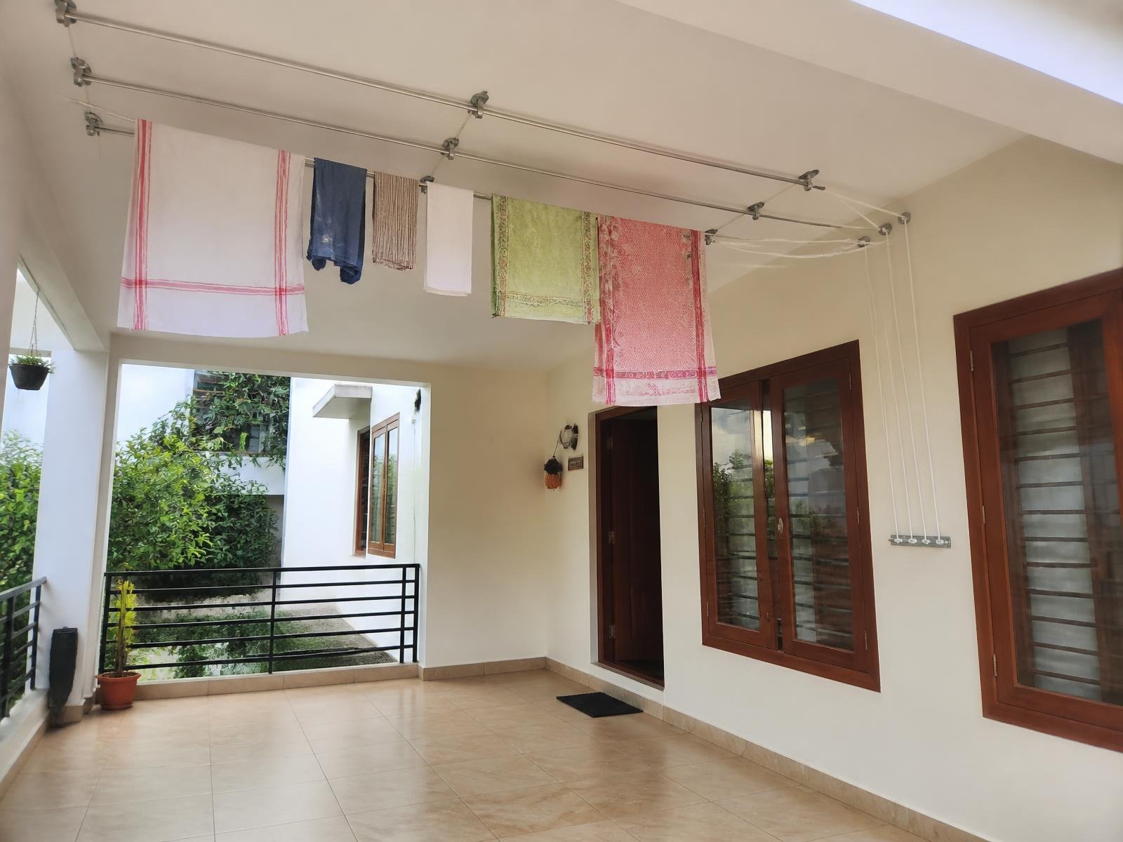 Verandah with a ceiling mounted pulley cloth hanger installed and clothes drying overhead